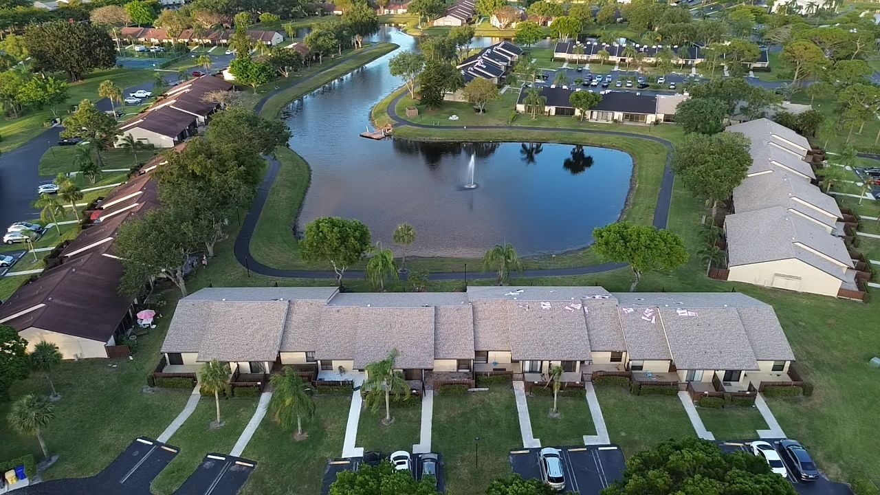 Completed roofs across a South Florida residential association surrounding a lake.