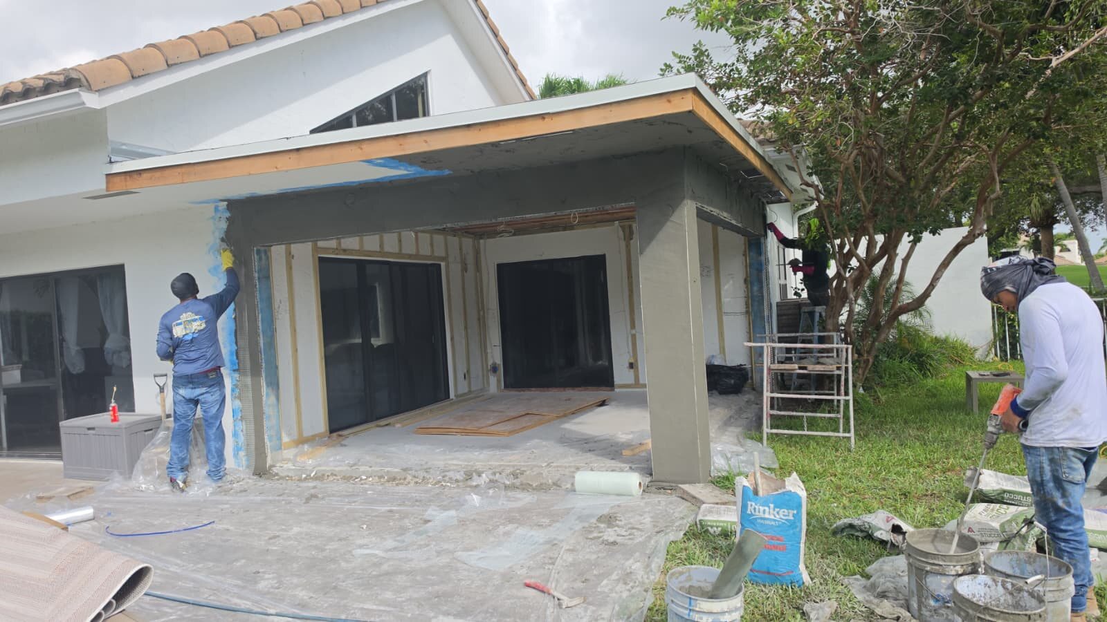 Storm Shield crew completing impact-window and sliding-door opening work.
