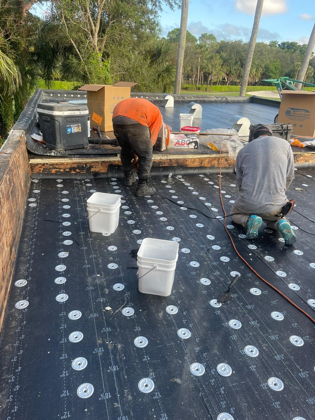 Storm Shield crew installing a low-slope roofing and waterproofing system.